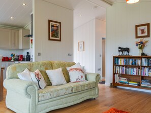 TV, fireplace - Canadian timber lodge with direct views to the Alpacas. (Rowrah, near Cockermouth)