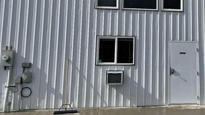 A white industrial building with a sign reading "ALLIED TRENCHLESS".