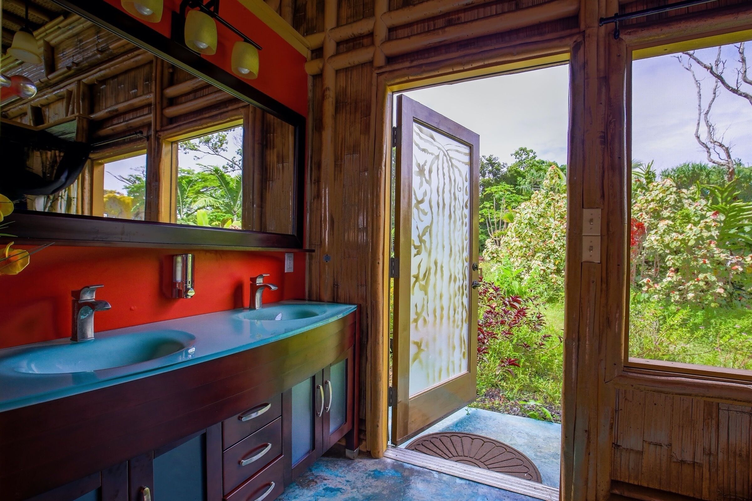 A wooden bathroom with two sinks and a large mirror.