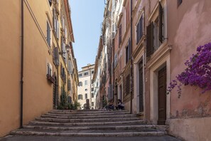 A narrow street with stone steps leading to a building entrance.