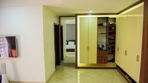 A room with a bed, a wardrobe, and a television. - Beautiful 4-Bedroom House Located in Abuja (Abuja)