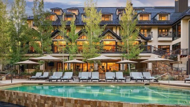 A hotel with a pool, lounge chairs, and umbrellas. - Westhaven 3 Bedroom Luxury Condo in Cascade Village, Steps to Chair Lift (Vail)