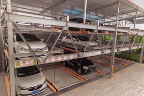 A multi-level car parking structure with several cars parked on different levels.
