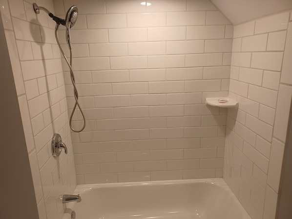 Combined shower/bathtub, hair dryer, towels, soap