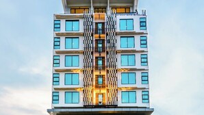 A modern hotel with a central atrium, multiple floors, and a prominent entrance. - EASTERN HOTEL BOJONEGORO (Bojonegoro)