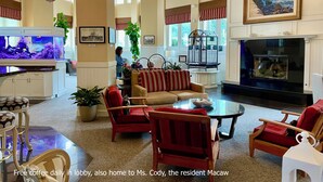 A spacious lobby with a large aquarium, comfortable seating, and a fireplace.