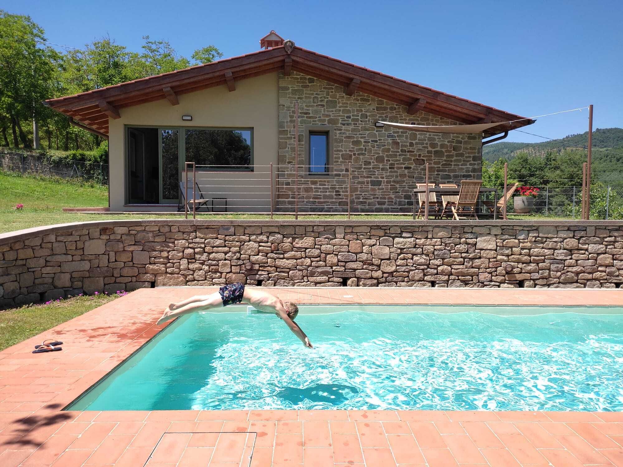 A stone building with a swimming pool.