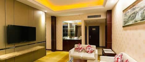 A modern living room with a flat-screen TV, a sofa, a coffee table, and a cabinet.