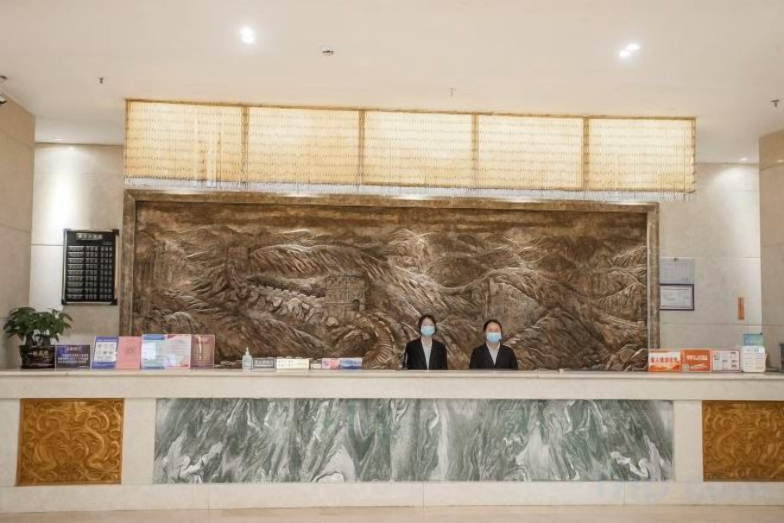 A reception desk with a large decorative wall, a bulletin board, and a few informational brochures.