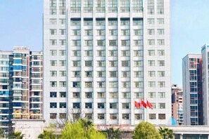 A high-rise building with multiple floors, likely a hotel or office building, with a uniform facade and a series of windows. - Nantian Hotel (Shangli)