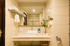 A hotel bathroom with a sink, mirror, towel rack, and a telephone. - Nantian Hotel (Shangli)