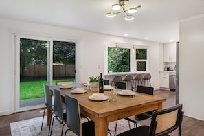 Enjoy meals in this dining area with a table for four, surrounded by a beautiful backyard view.