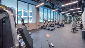 A gym with treadmills, weight machines, and exercise equipment.