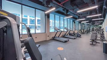 A gym with treadmills, weight machines, and exercise equipment.