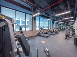 A gym with treadmills, weight machines, and exercise equipment.