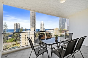 Enjoy dining or socializing on the balcony with a view of the city and ocean.