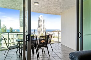 Enjoy ocean views from this spacious balcony with a glass door leading to a dining area.