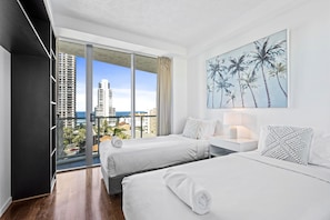 Enjoy a city and ocean view from the comfort of this stylish room featuring two single beds and a large window.