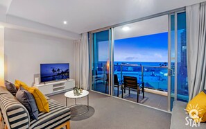 Enjoy a panoramic view of the city and sea from this hotel room's balcony.