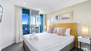 A hotel room with a large bed, a view of the city, and two framed pictures on the wall. - H'Residences – Cozy 2 Bed Hinterland View — Q Stay (Surfers Paradise)