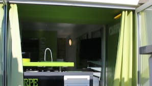 A green interior with a sink and cabinets. - Cozy Air-Conditioned Studio for 2 with Terrace & Parking in Agde (Cap d'Agde naturisme)