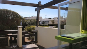 A balcony with a view of buildings and a clear sky. - Cozy Air-Conditioned Studio for 2 with Terrace & Parking in Agde (Cap d'Agde naturisme)