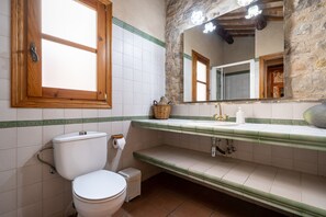 A bathroom with a toilet, a sink, a mirror, and a window. - Apartment 'El Clos 3' with Mountain Views, Private Terrace and Wi-Fi (CONESA)