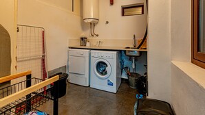 A laundry area with a washing machine, dryer, and a water heater.