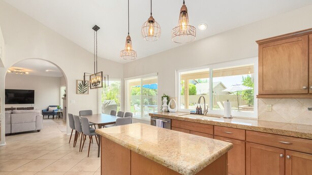 A modern kitchen with granite countertops, wooden cabinets, and pendant lighting. - *Great Rates Available* | North Scottsdale Peaceful Paradise (Scottsdale)
