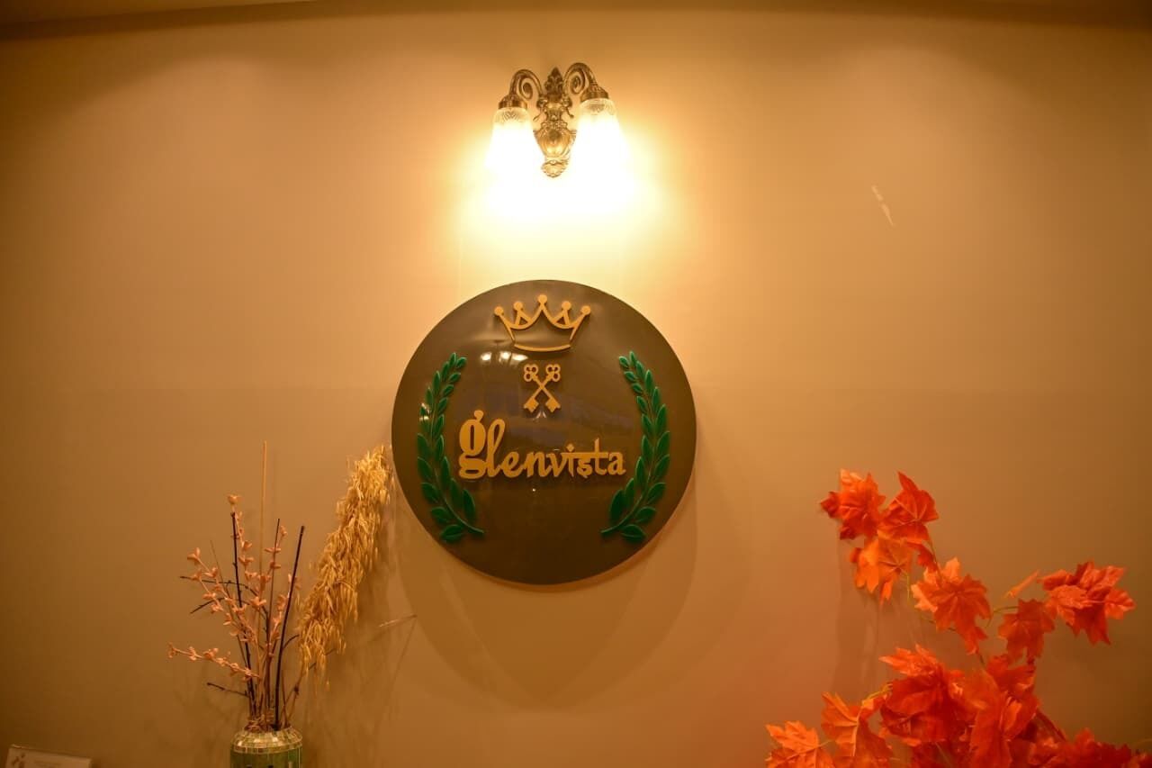 Un letrero en la pared con el nombre 'Glenvista' y un símbolo de corona.
