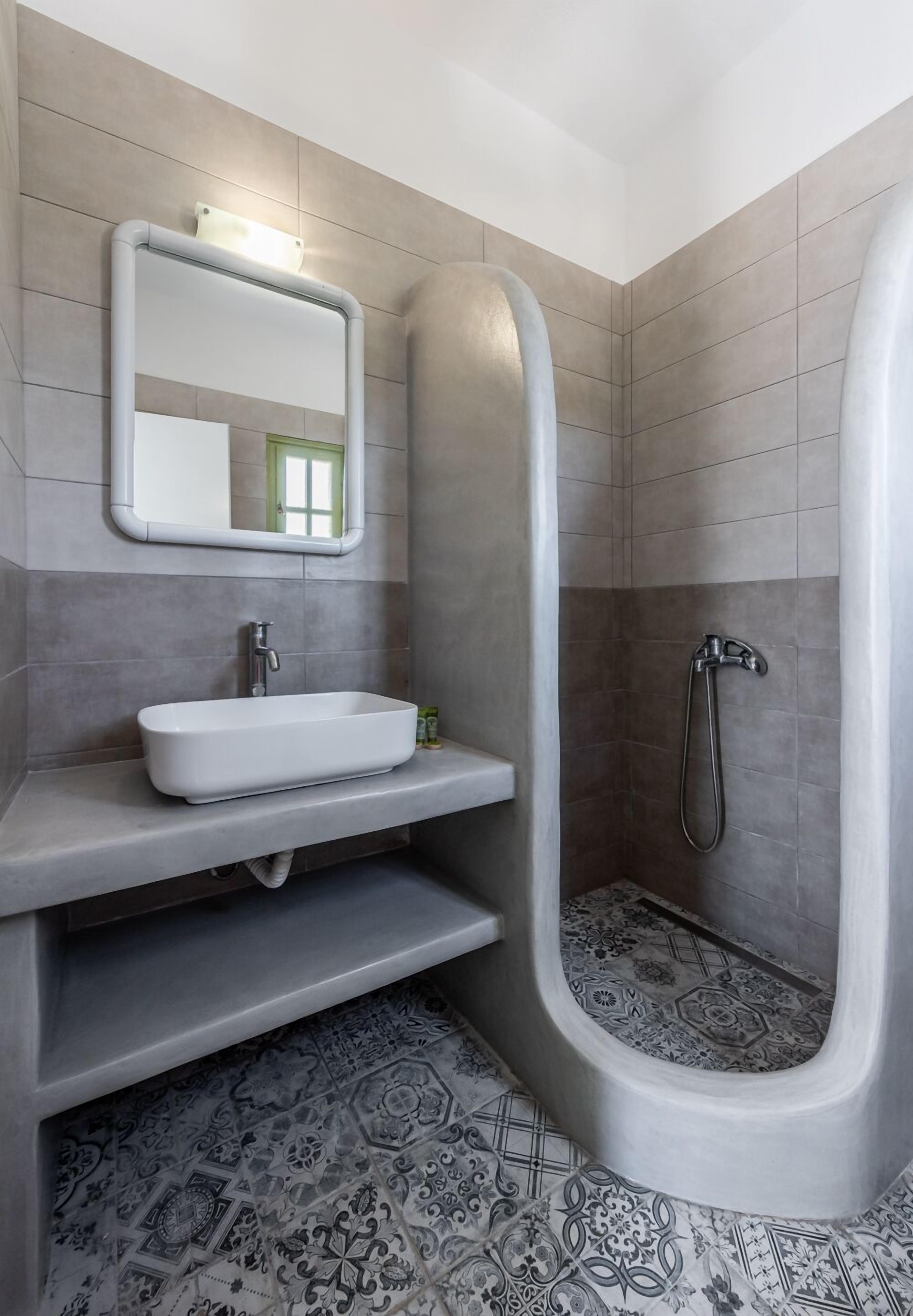 A modern bathroom with a freestanding bathtub, a sink, and a shower.