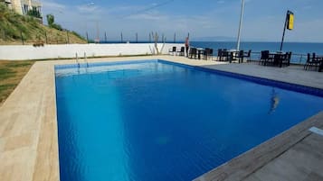 Seasonal outdoor pool, open 10:00 AM to 6:30 PM, pool umbrellas