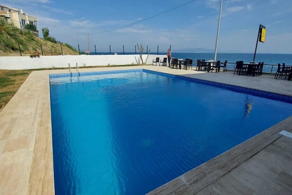 Seasonal outdoor pool, open 10:00 AM to 6:30 PM, pool umbrellas