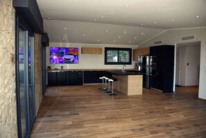 Enjoy cooking in this well-equipped kitchen with a central island and bar stools.