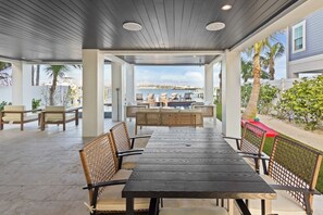Outdoor dining - Waterfront Luxury Home with Pool and Spa, Golf Cart, and beach Bikes included! (Bradenton Beach)