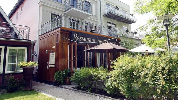 Kaksikerroksinen rakennus, jonka alakerrassa on ravintola.