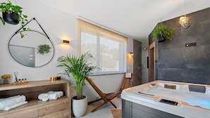 A modern bathroom with a wooden vanity, a large mirror, a potted plant, a hot tub, and a window with a view. - Luxury Villa Praska with 3 en-suite bedrooms, Finnish Sauna, private pool (Podstrana)