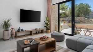 A modern living room with a flat-screen TV, wooden console, and a grey sofa. - Luxury Villa Praska with 3 en-suite bedrooms, Finnish Sauna, private pool (Podstrana)