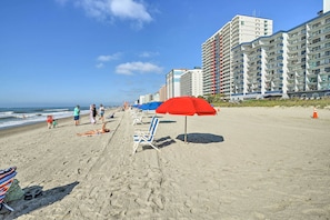 Relax on the beach with sun loungers and umbrellas, overlooking the ocean from our modern high-rise buildings.