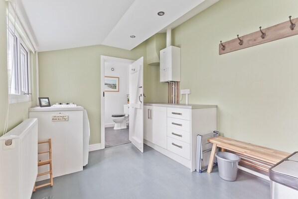 A compact bathroom with a toilet, a sink, and a mirror.