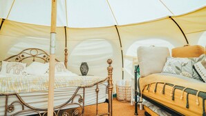 A tent with two beds, each with a wooden frame and white bedding. There is a woven basket and a lamp on one bed. - Luxury Tent-Peaceful Meadow-Firepit-Superb Views.Dogs WiFi-Beaches 10 mins SAUNA (Truro)