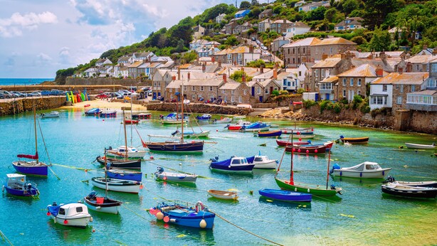 A coastal village with colorful boats docked in a harbor, surrounded by stone houses with steep roofs. - Luxury Tent-Peaceful Meadow-Firepit-Superb Views.Dogs WiFi-Beaches 10 mins SAUNA (Truro)