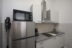 A compact kitchen with a built-in microwave, a coffee maker, and a sink. - Apartment SoMi 2 (Poreč)