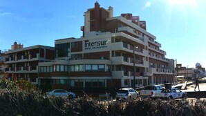 A multi-story hotel with a prominent sign for 'Intersur Hotel Village'. - Intersur Villa Gesell (Villa Gesell)