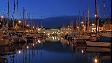 Stunning marina views with boats docked in the calm water, surrounded by urban buildings.
