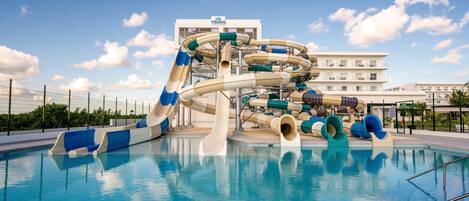 A water park with multiple slides and a pool.