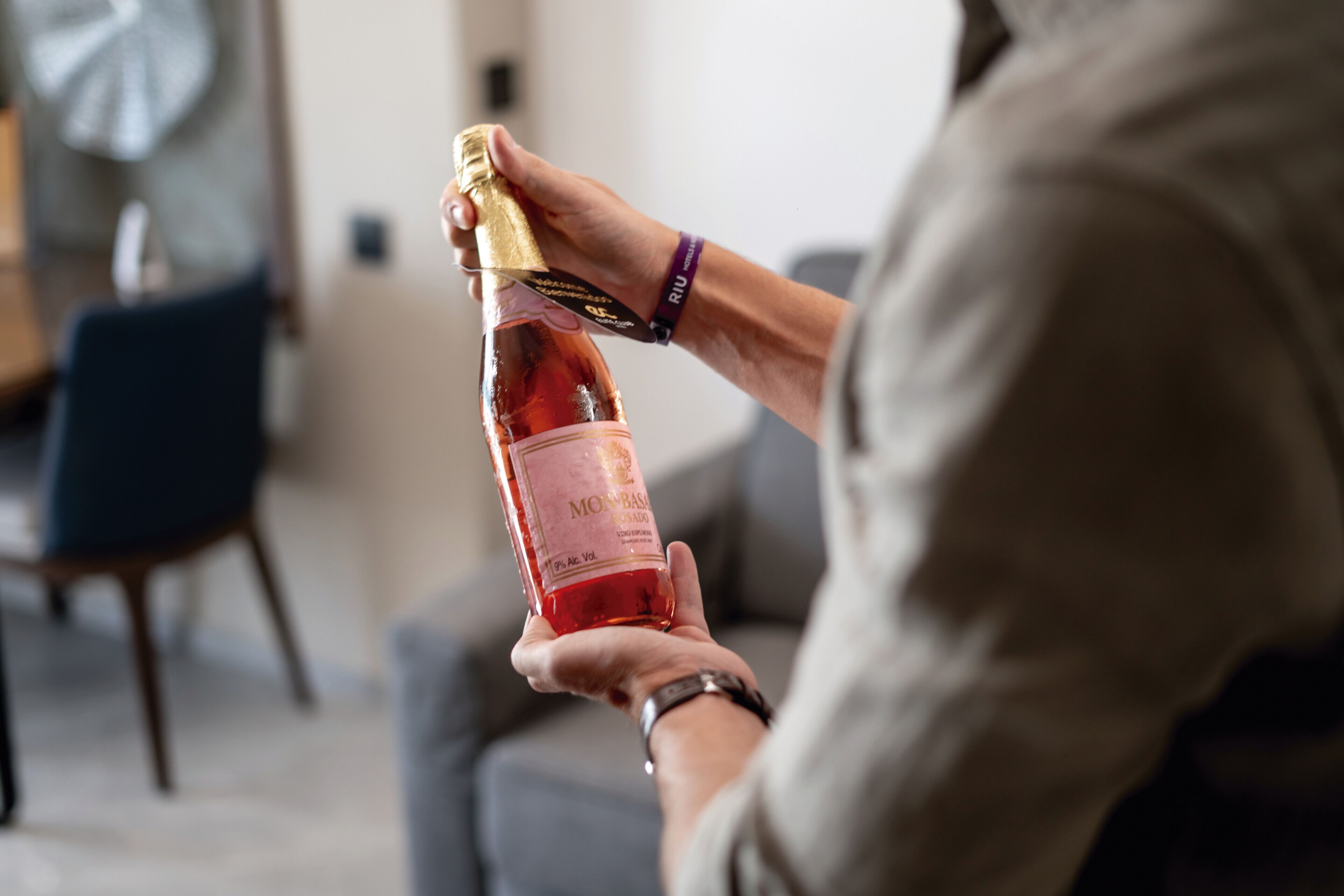 A person holding a bottle of Monbazaar wine.