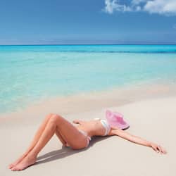 Guests can relax on the sandy beach overlooking the turquoise waters.