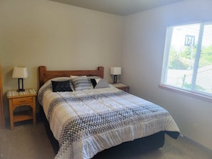 Cozy retreat with a single bed, two bedside tables, and a nightstand.