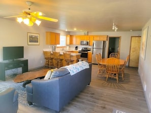 Relax in this open-plan living space with a large sofa and dining area.